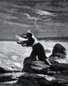 a woman sitting on top of a rock next to the ocean under a cloudy sky