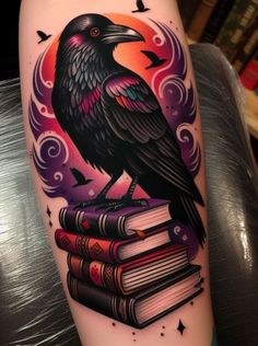 a black bird sitting on top of some books