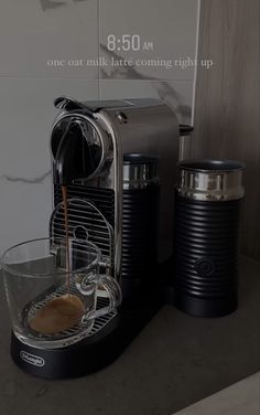 the coffee machine is being filled with liquid