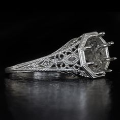 an antique style diamond ring on a black background