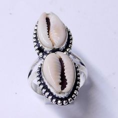 Weight of ring 5.5 Gm Head Sell Size 11x33 mm (APPROX.) 100% Cowrie shell natural stone, Metal:Sterling Silver Stamped:925 i make jewelry for a very special kind of Women's men's ,This stunning is handcrafted by one of our talented artisans. It is set in precious Fine Jewelry 925 Sterling Silver Jewelry, Polished to a brilliant luster> You can also contact us for a separate order, or place an order? Send items back within: 30 days of delivery Request a cancellation within: 2 Hours of purchase Silver Shell-shaped Ring For Gift, Handmade Open Ring Jewelry For Beach, Silver Shell Rings For Beach, Silver Shell Rings For Gift, Unique White Shell Jewelry, Handmade White Shell Rings, Bohemian Oval Jewelry For The Beach, Bohemian Oval Jewelry For Beach, Silver Shell-shaped Rings For Beach