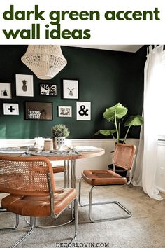 a dining room with green walls and pictures on the wall