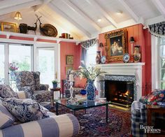 a living room filled with furniture and a fire place under a painting on the wall