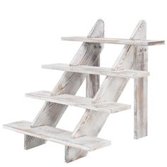 a white wooden shelf with three shelves on each side