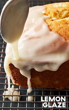 a lemon glaze cake on a cooling rack with a spoon sticking out of it