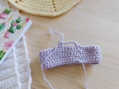 two crocheted items are sitting on a table