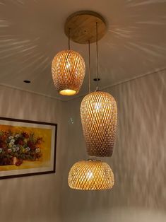 three lights hanging from the ceiling in a room