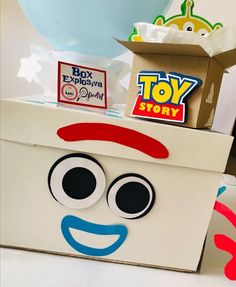 a box that has some kind of toy in it with eyes and nose on top