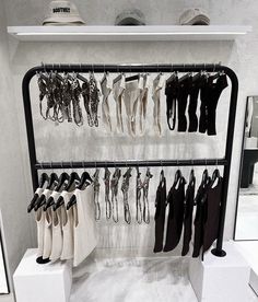 a rack with several pairs of shoes hanging from it's sides and other items on display