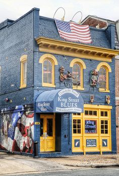 a blue and yellow building with an american flag on top