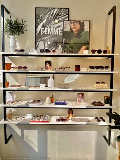 an eyeglass display in a store filled with lots of glasses and other items on shelves