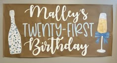 a sign that says mallys's twenty - first birthday with two champagne bottles