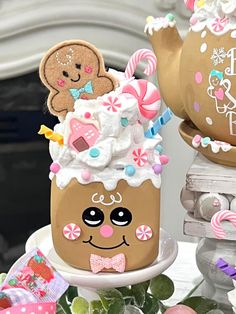 there is a cake decorated like a cupcake with a teddy bear on top and other decorations around it