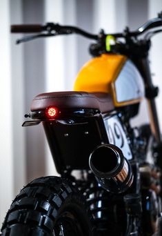 a close up of a motorcycle with its lights on