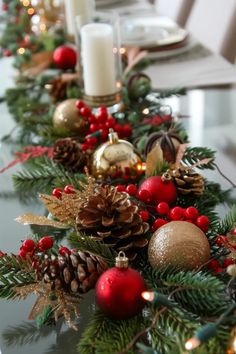 a christmas table runner with pine cones and ornaments