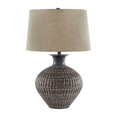 a table lamp with a beige shade on it and a light brown shade on the base