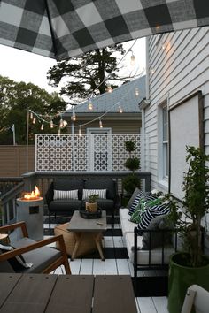 an outdoor living area with patio furniture and lights