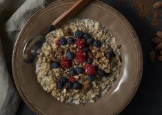 a bowl of oatmeal with berries and nuts