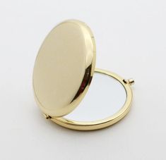 an open compact mirror on a white surface