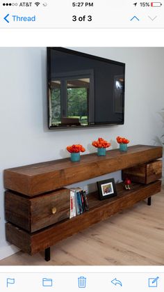 a wooden entertainment center with flowers on top