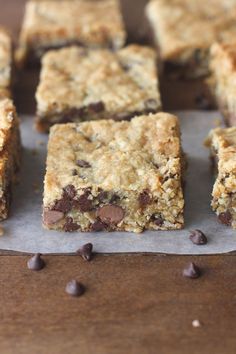 chocolate chip bars cut into squares on top of parchment paper