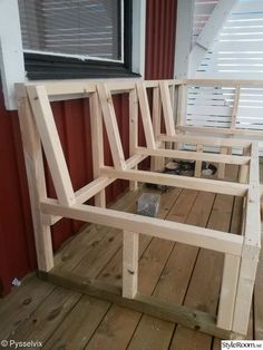 a wooden bench sitting on top of a wooden floor