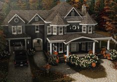 a painting of a house with pumpkins in the front yard and flowers on the driveway