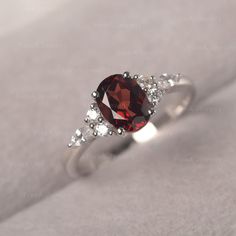 * The delicate ring displays Garnet as main stone. The cluster side stones make the ring similar to the blooming flower . For who wearing this special & delicate ring, will shine like a goddess. ◆ Production Description: Main stone Type: Garnet Main Stone Shape: Oval Cut Main Stone Size: 6*8mm(1.73ct) Side stone: CZ Metal: 925 Sterling silver - Other options available in the drop down menu ◆ Customization: √Free for Add Engraving √Other Metal Type Available √Other Gemstones & Shapes Avai Oval Cluster Ring With Gemstone Accents For Gift, Oval Cluster Ring With Gemstone Accents, Elegant Crystal Promise Ring With Gemstone Accents, Elegant Crystal Ring With Gemstone Accents As Promise Ring, Elegant Crystal Ring With Gemstone Accents For Promise, Exquisite Oval Ruby Promise Ring, Elegant Oval Garnet Birthstone Ring, Delicate Oval Gemstone Birthstone Ring, Delicate Oval Crystal Promise Ring