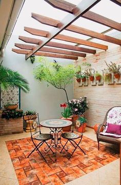 an outdoor patio with potted plants and chairs