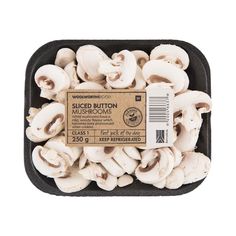 sliced mushrooms in a black tray on a white background with a label for the product