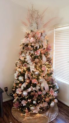 a decorated christmas tree with pink and white ornaments