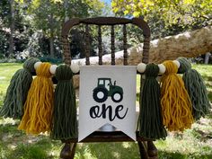 a chair with tassels and a sign that says one