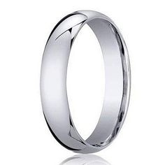 a white gold wedding ring with an elegant design on the outside, and a rounded surface