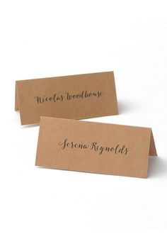 two place cards with black ink on them