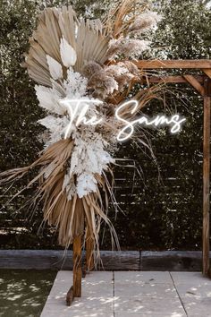 a tall wooden pole with dried flowers on it