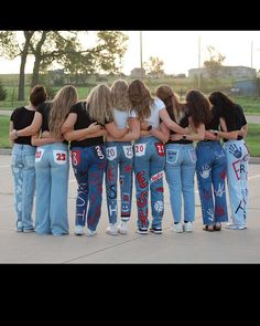 a group of girls standing in a circle with their backs to each other