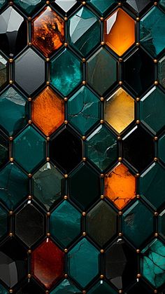 a close up view of an abstract glass mosaic tile pattern with orange and green colors