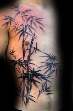 a man's chest with bamboo leaves on it