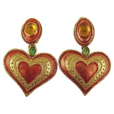 YVES SAINT LAURENT vintage gold toned heart dangling earrings (clip-on) featuring a gorgeous lace detail, orange enamel, green crystal and glass cabochon embellishement. Embossed YSL Made in France. Indicative measurements : height approx. 6.3 cm (2.48 inches) / max. width approx. 4.1 cm (1.61 inches). NOTES - This is a preloved vintage item, therefore it might have imperfections. - Colors may differ slightly from actual product appearance due to differences in lighting conditions. - As a buyer, Luxury Retro Earrings As Gift, Luxury Retro Red Jewelry, Luxury Red Retro Jewelry, Saint Laurent Heart Earrings, Vintage Heart Jewelry, Big Earrings Gold, 70s Accessories, Ysl Vintage, Lizzie Hearts