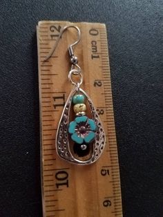 This listing is for one pair of Czech turquoise hibiscus flower earrings framed in silver. Beautiful turquoise flower topped by turquoise and antiqued bone colored Picasso glass. Great compliment to a Southwest or boho look. Great gift for mom. Measures 48x16mm hooks 35x16mm posts Save on shipping! I will batch ship items in an order for one price or Free shipping on orders of $20 or more. Use coupon code FREESHIP2019 at checkout Adjustable Turquoise Flower Pendant Jewelry, Adjustable Pierced Metal Flower Earrings, Unique Jewelry With Flower Charm, Silver Flower Pendant Jewelry With Matching Earrings, Turquoise Teardrop Metal Jewelry, Turquoise Teardrop Flower Earrings For Gift, Adjustable Silver Bohemian Flower Earrings, Vintage Nickel Free Metal Flower Earrings, Vintage Nickel-free Metal Flower Earrings