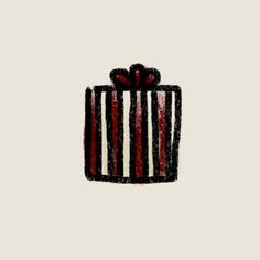 a black and white striped gift box with a red bow on it's top