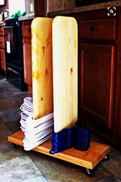 a wooden rack with stacks of blue and white plates on top of it in a kitchen