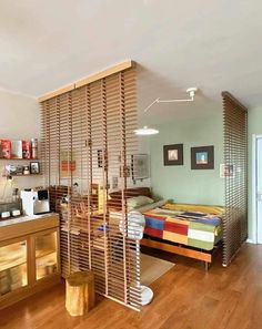 a bedroom with a bed and wooden slats on the wall next to a window