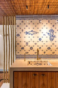 a kitchen with wooden cabinets and tile backsplashing, along with an under - cabinet sink