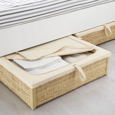 an open wicker basket under a bed