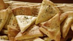 a basket filled with cheese and crackers on top of a table