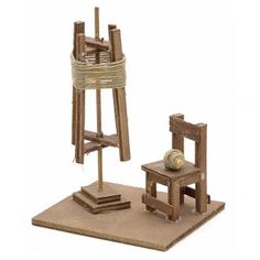 a miniature wooden chair next to a small easel