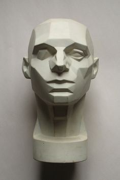 a white head statue sitting on top of a table