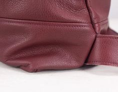 "The Minos backpack made out of a soft burgundy soft Italian cowhide. It comes in two sizes. The Minos-13 that fits a 13\" MacBook inside and the Minos-15 for up to 15\" MacBook. Customizations regarding sizes or the laptop pocket's size inside are always welcome. This backpack is great for all your everyday necessities including your 13\" or 15\" MacBook, work papers, magazines etc. In front, there are two zippered vertical pockets sealed with YKK brass zippers placed on each side. They measure Daily Use Burgundy Leather Backpack, Everyday Burgundy Leather Backpack, Burgundy Leather Backpack With Adjustable Strap For Everyday, Burgundy Leather Backpack With Adjustable Strap, Burgundy Leather Travel Backpack, Burgundy Leather Standard Backpack, Leather Backpack With Adjustable Strap In Burgundy, Leather Burgundy Backpack With Adjustable Strap, Burgundy Backpack With Adjustable Strap For Daily Use