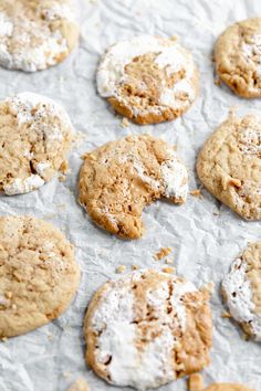 cookies covered in powdered sugar on top of wax paper